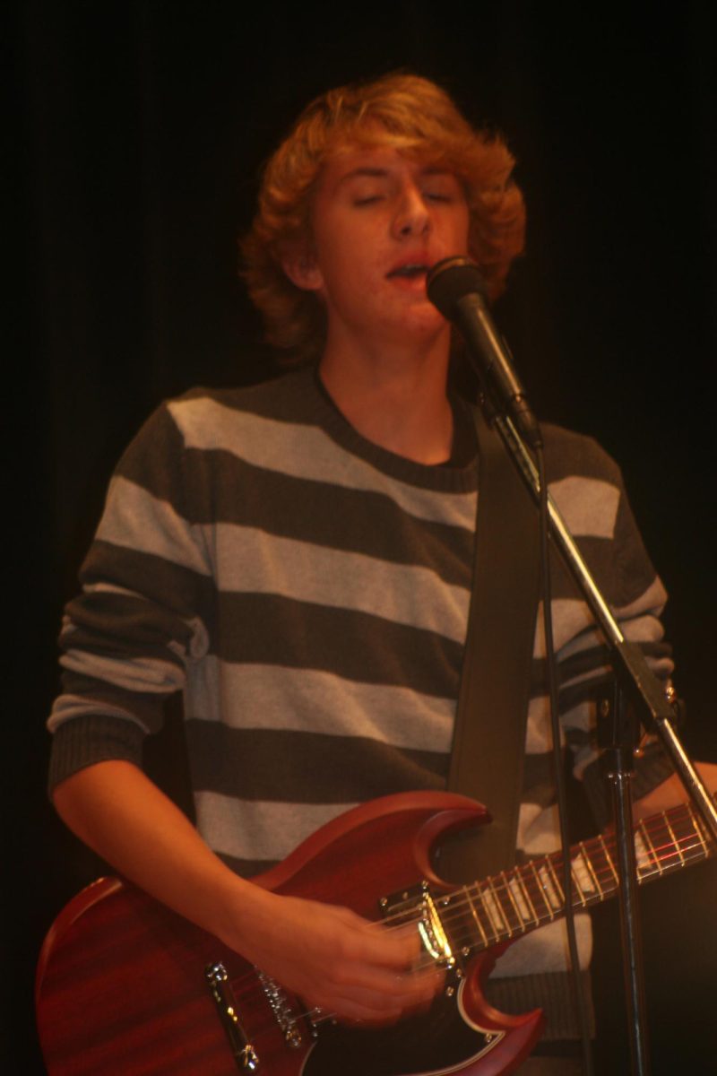 Battle of the Bands contestant playing the guitar