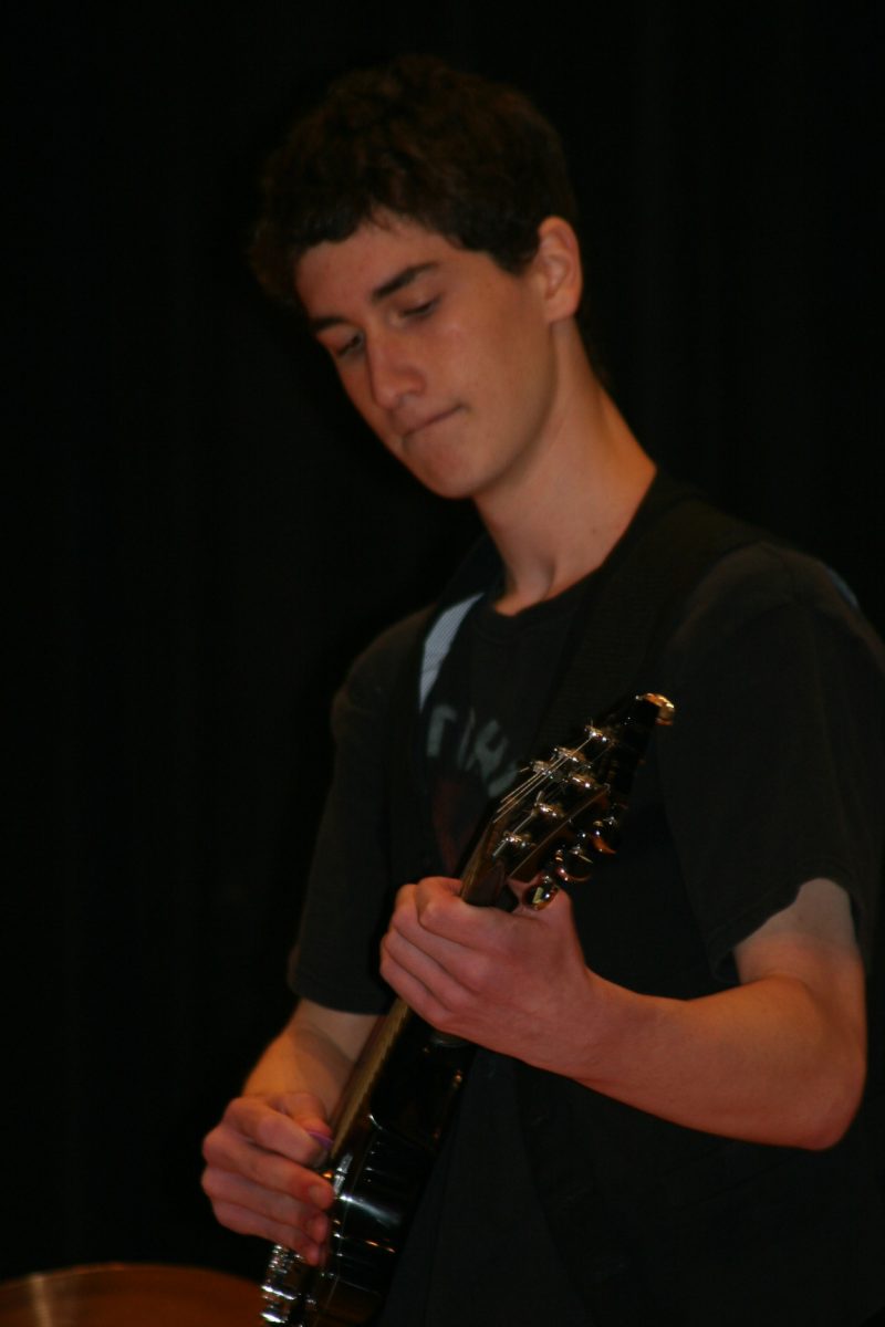 Battle of the Bands contestant playing the guitar