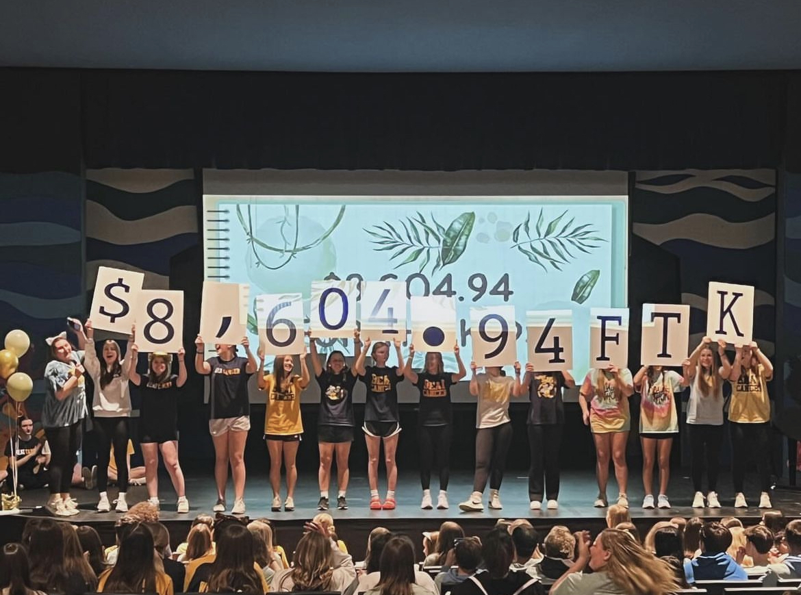 Last year during Mini-Mini-THON members held up the total that they have raised.