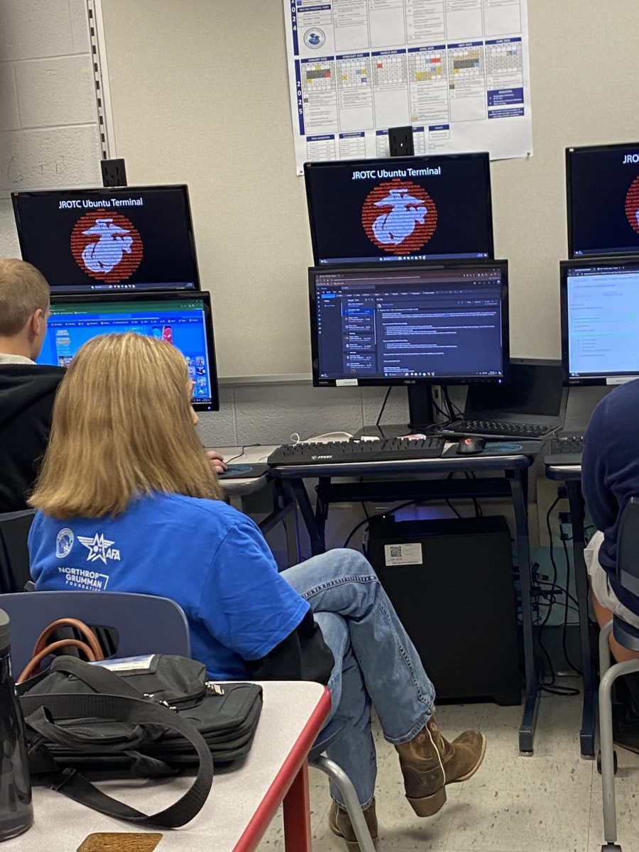 MCJROTC cadets are shown in the JROTC classroom during a CyberPatriots competition.