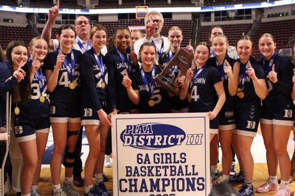 Dallastown Girls' basketball gestures 'number one' after winning the PIAA District III 6A Girls Basketball Championship at the Giant Center in Hershey. 