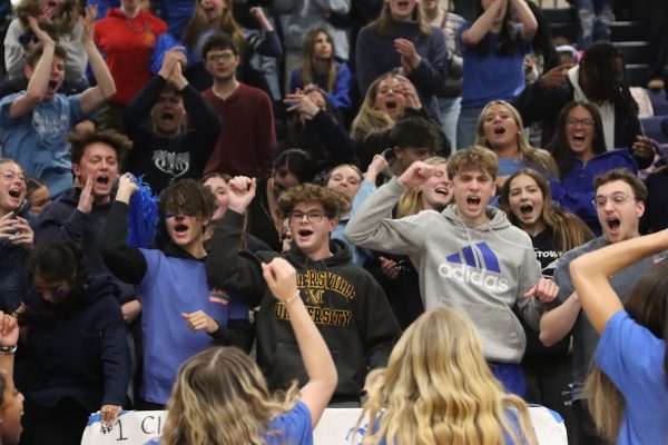 The senior class participating in the class cheer competition by cheering as loud as they can.