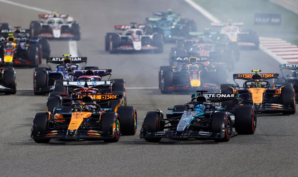 Formula One F1 - Bahrain Grand Prix - Bahrain International Circuit, Sakhir, Bahrain - April 13, 2025 McLaren's Oscar Piastri leads into the first corner at the start of the race ahead of Mercedes' George Russell REUTERS/Rula Rouhana     TPX IMAGES OF THE DAY
