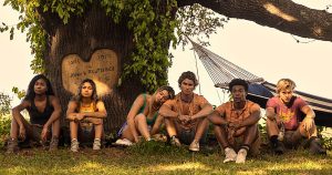 From Netflix
Outer Banks Cast sits by a tree