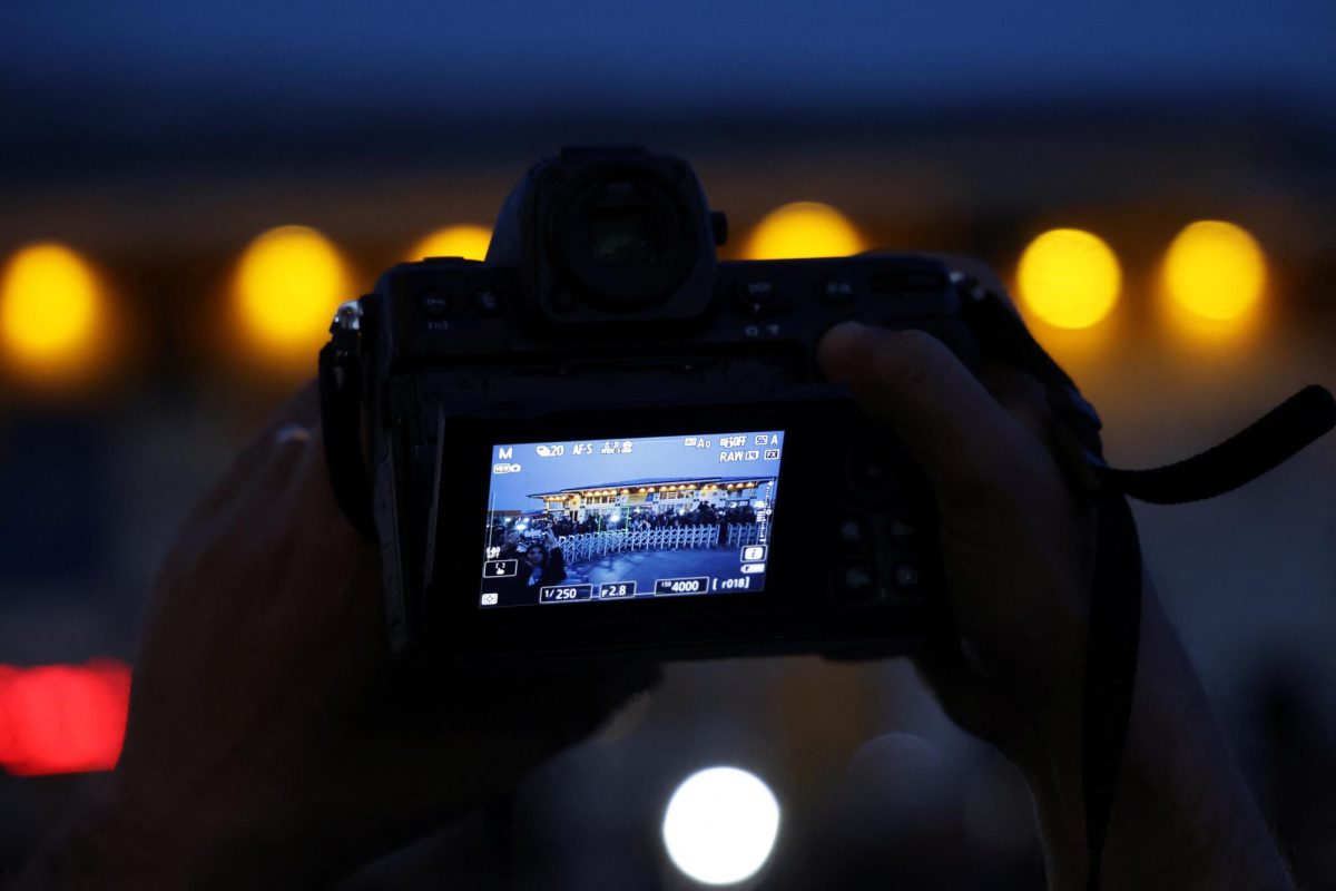 A camera is held as journalists gather outside the Turkish Presidency's Dolmabahce working office, where Russia and Ukraine direct talks might happen, in Istanbul, Turkey, May 15, 2025. REUTERS/Leonhard Foeger