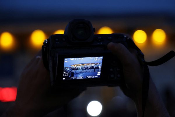 A camera is held as journalists gather outside the Turkish Presidency's Dolmabahce working office, where Russia and Ukraine direct talks might happen, in Istanbul, Turkey, May 15, 2025. REUTERS/Leonhard Foeger