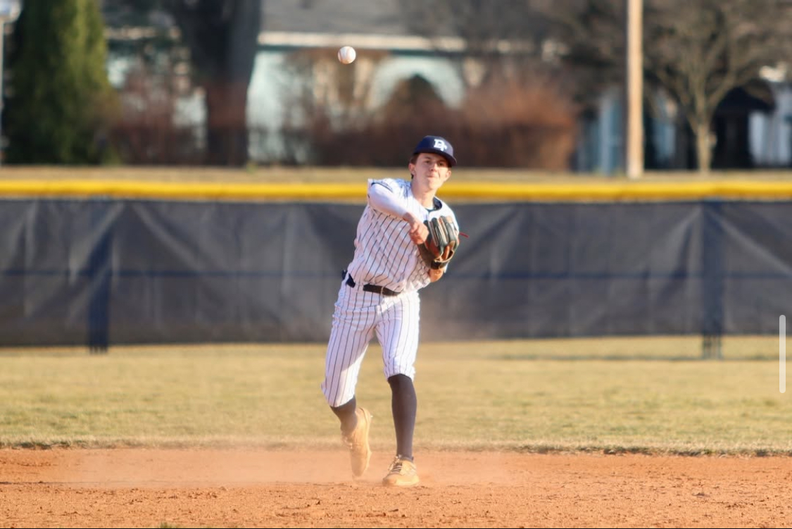 Shortstop Kaden Beaverson throws a ball to get the runner out 