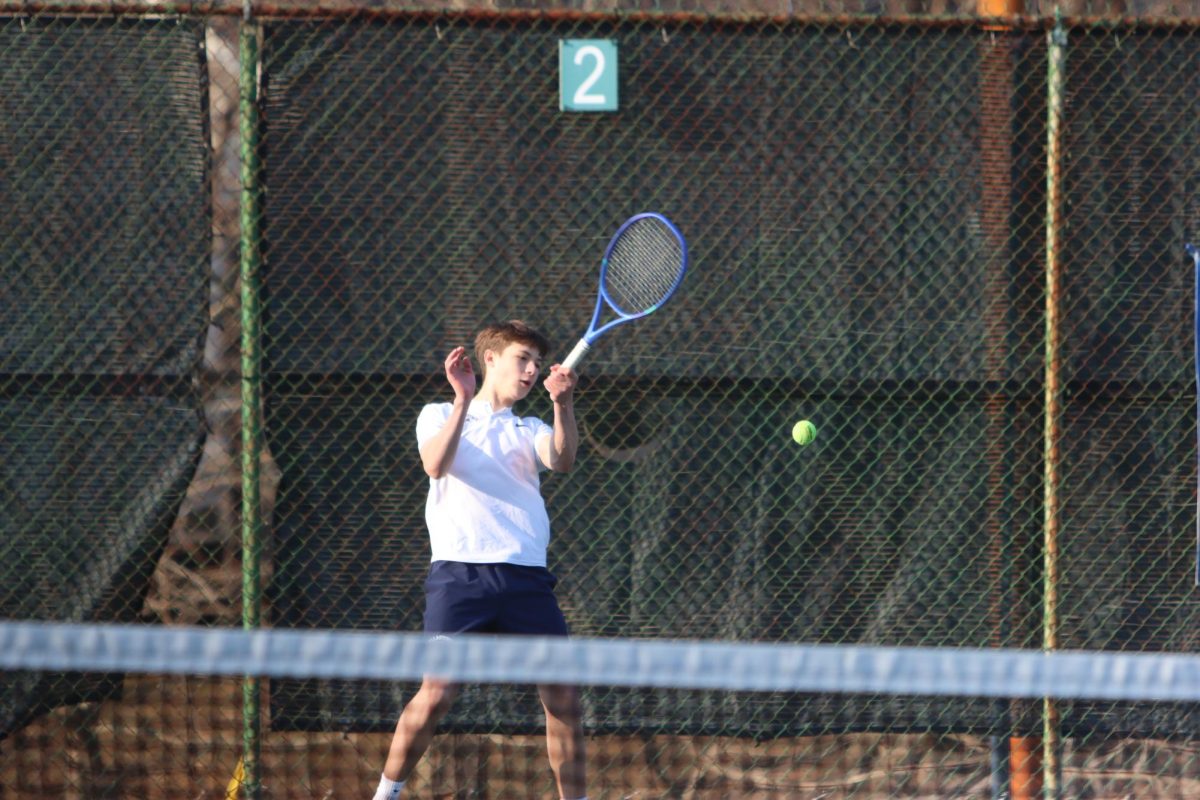 Senior Jacob Horn is returning a serve.