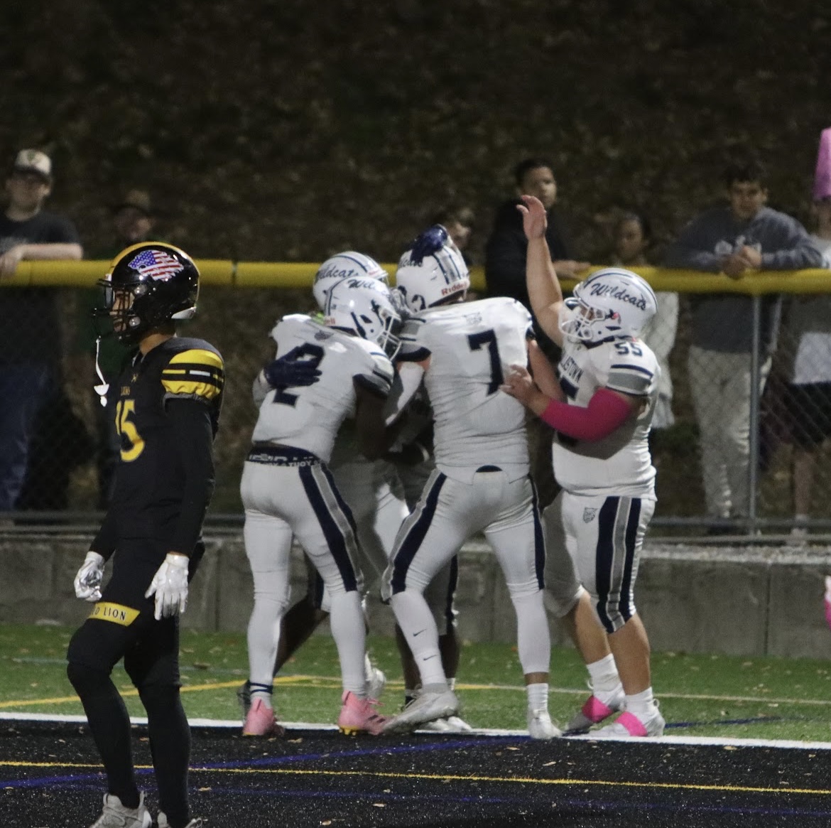 Picture of Dallastown football players huddled together celebrating a touchdown