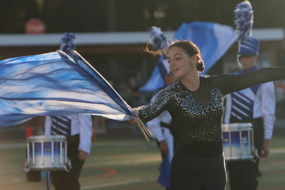 Senior Maggie Polek performs with precision and energy during the first football game of the season. 