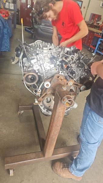 A part-time student at Tech is taking apart an engine, one of many interesting tasks they are given during class. (Taylor Spevak )