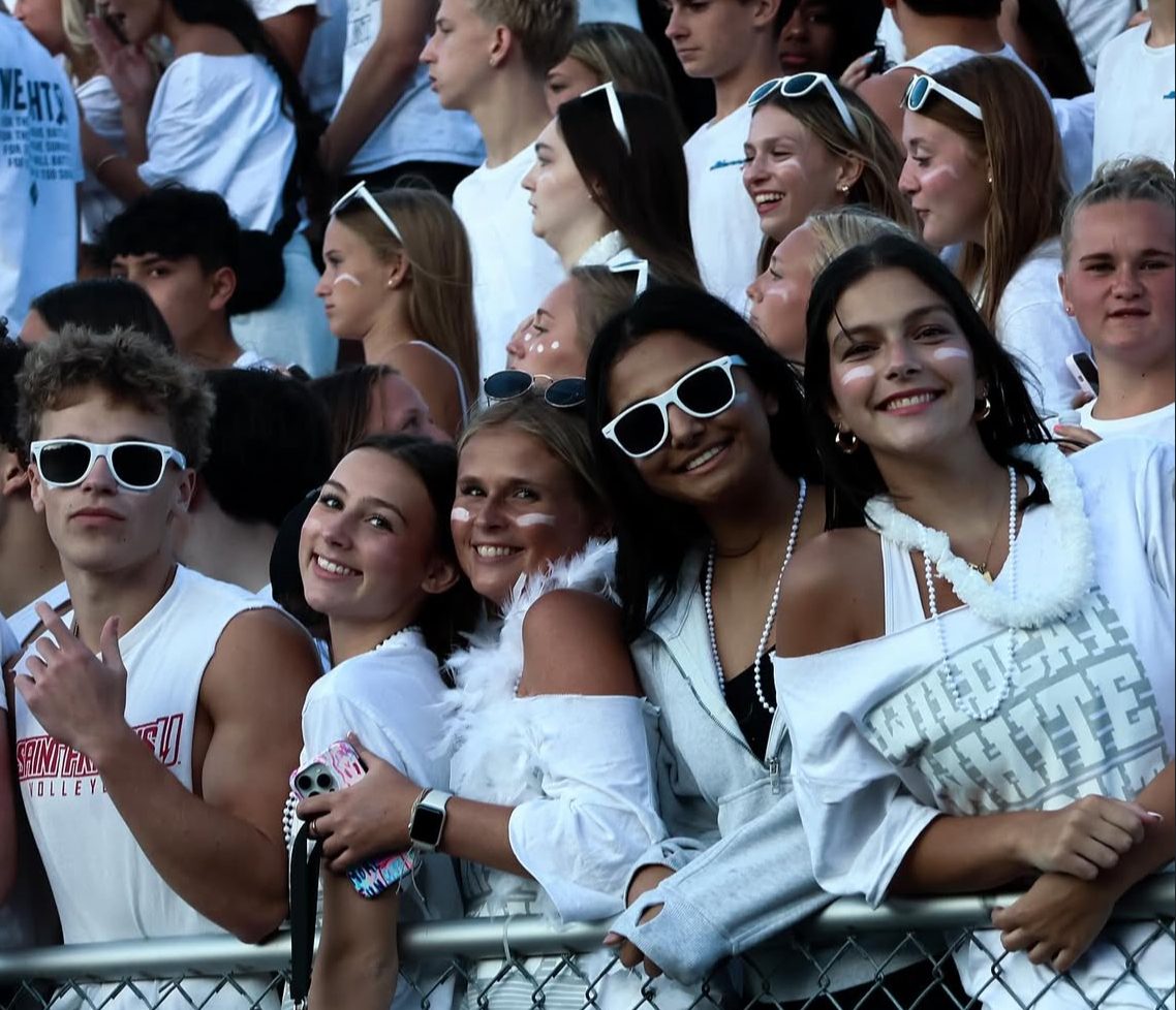 Attending the Wildcat White-Out football game, Sophia Long (far right) poses with friends. Between juggling a busy schedule and the pressure of senior year, Long still prioritizes her passion for connecting to the student body as well as her role as Student Representative on the Dallastown School Board.