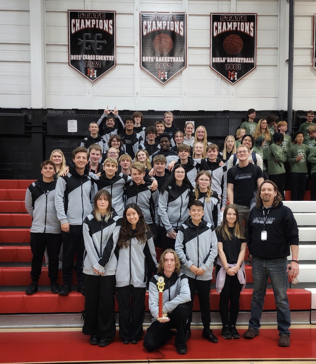 Zane Ruth (bottom far right) stands alongside the 2024-25 Dallastown Indoor Drumline after their third consecutive first-place win of the season during a competition at North Hagerstown High School. Photo Submitted.