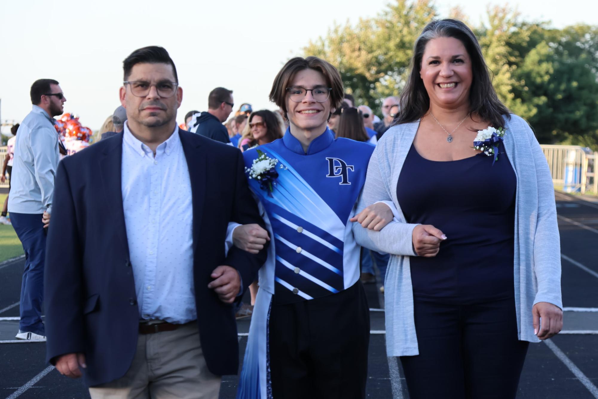 Senior Vincent Cialini (Middle) with his mother and father during the Marching band's senior night. (Madisyn Ruane)