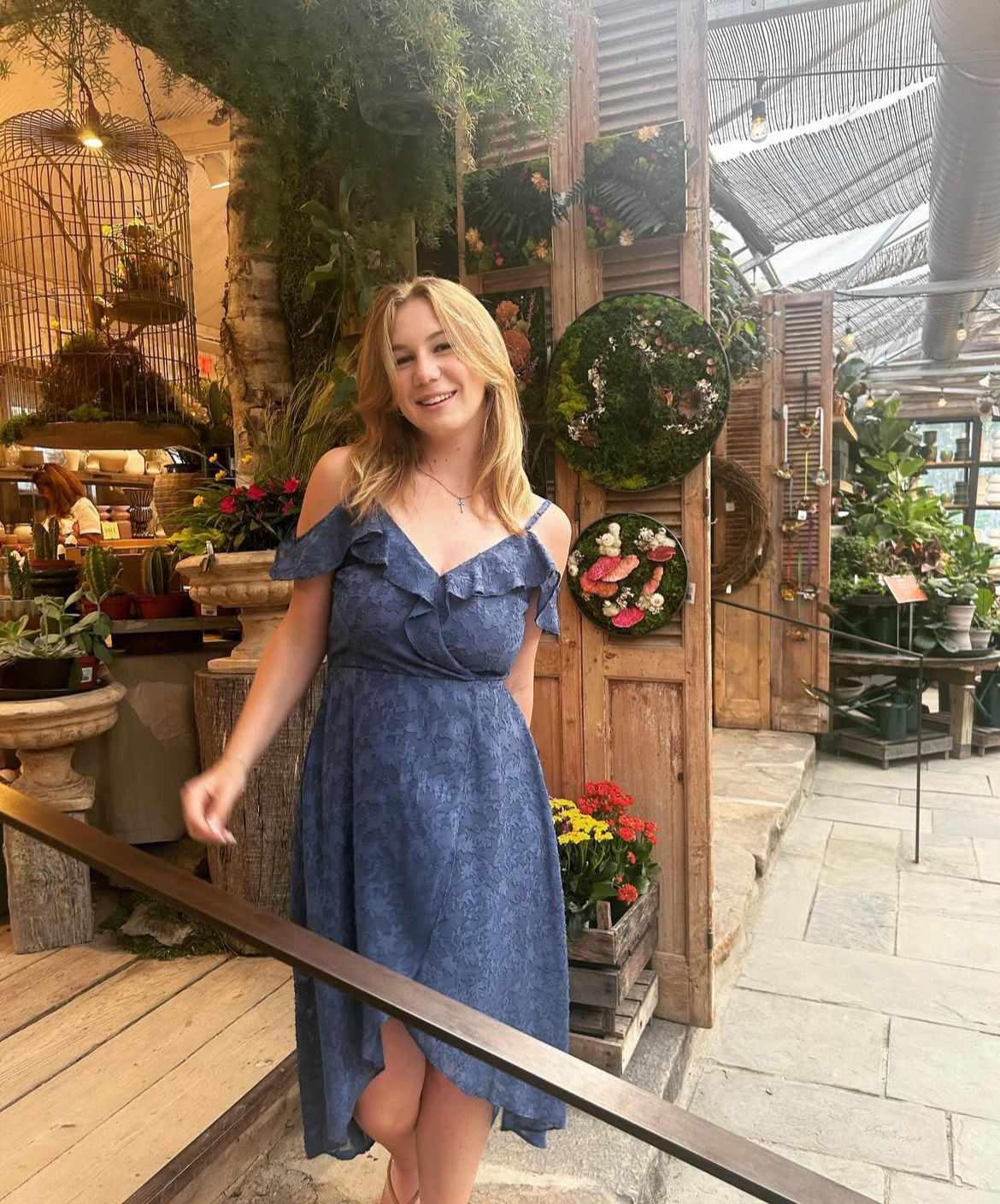 Senior Jules Gutekunst shows a kind and compassionate nature through poses in front of flowers, complimenting her carefree spirit.