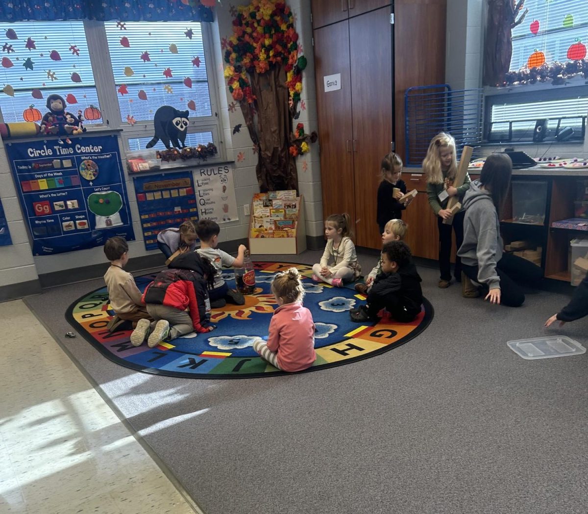 Students of DHS, participating in the preschool course of the Childcare class, teaching the preschoolers how to clean up their toys properly.