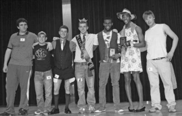 7 contestants from the 2011 Mr. DHS pageants standing together with the winner placed in the middle, dressed in a crown and sash.