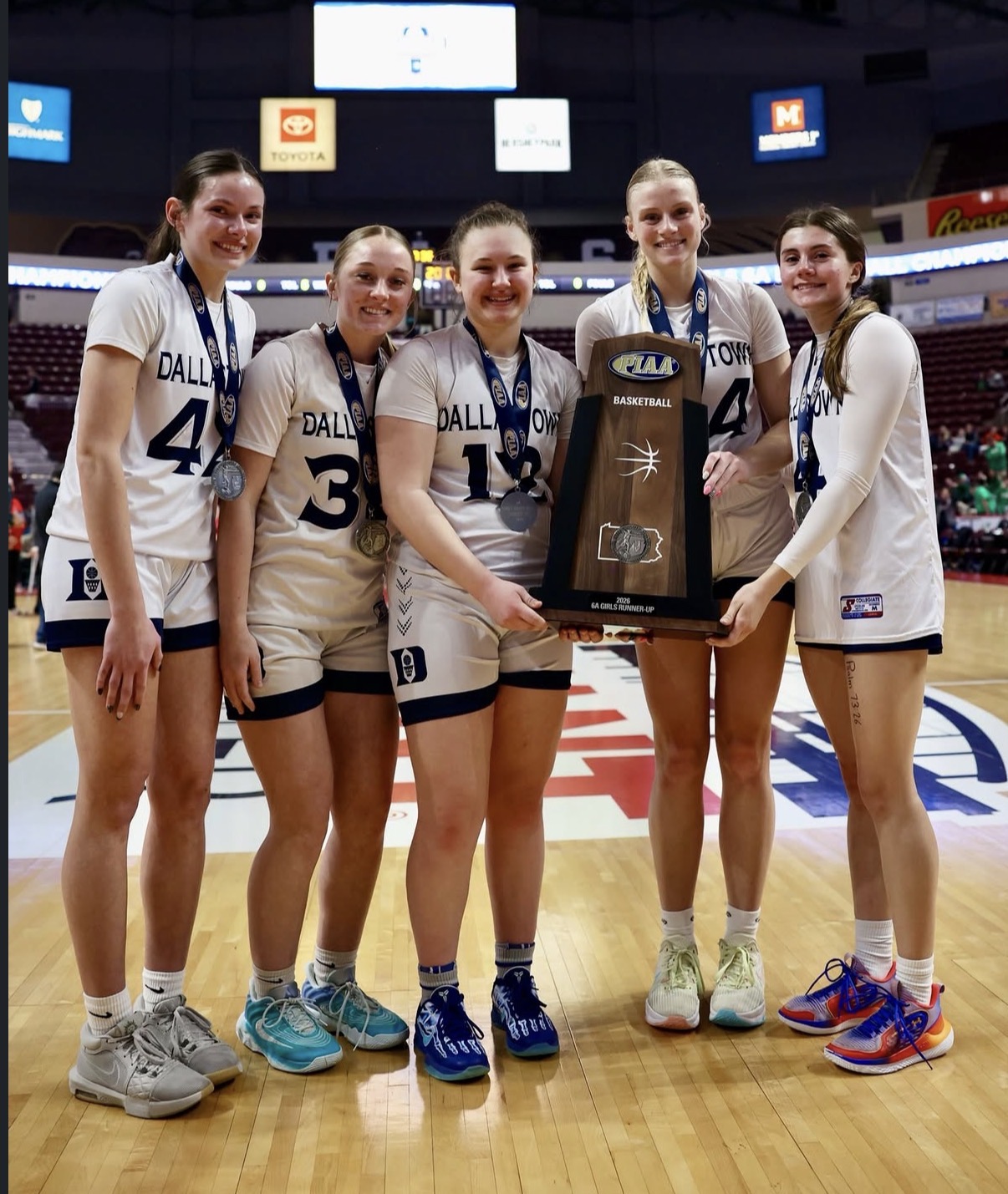Dallastown Girls’ Basketball Seniors Marleigh Blasser, Abby Lintz, Sophia Scovitch, Ava Jamison, and Olivia Cleaver (left to right) pose at the Giant Center with their PIAA 6A State Runner-Up trophy. (Richard Veytsman)