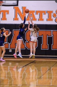 Callie Crowe blocking a shot during a basketball game for Dallastown in between the severe knee injuries she has faced. (Image sent by Crowe).