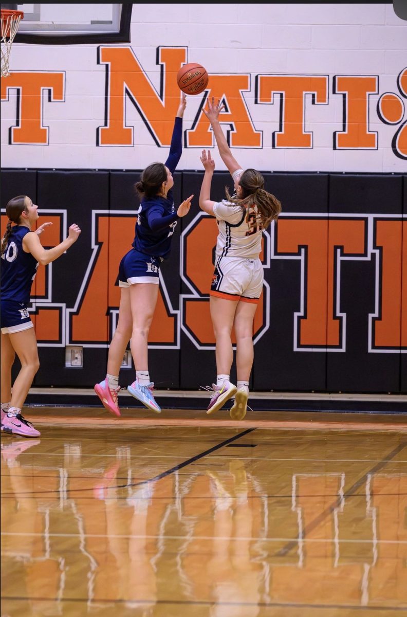 Callie Crowe blocking a shot during a basketball game for Dallastown in between the severe knee injuries she has faced. (Image sent by Crowe).